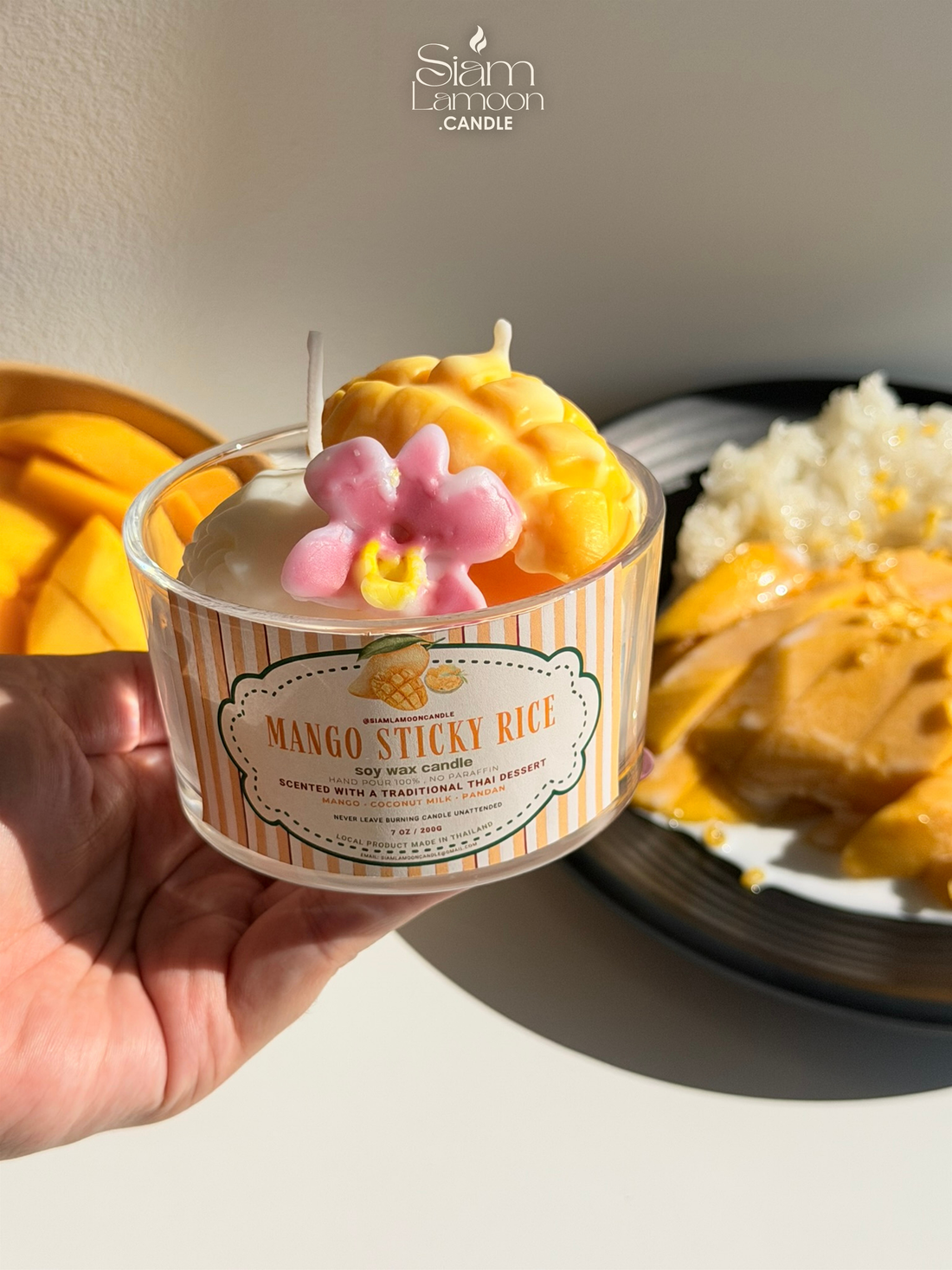 Hand holding a Siamlamoon Mango Sticky Rice candle