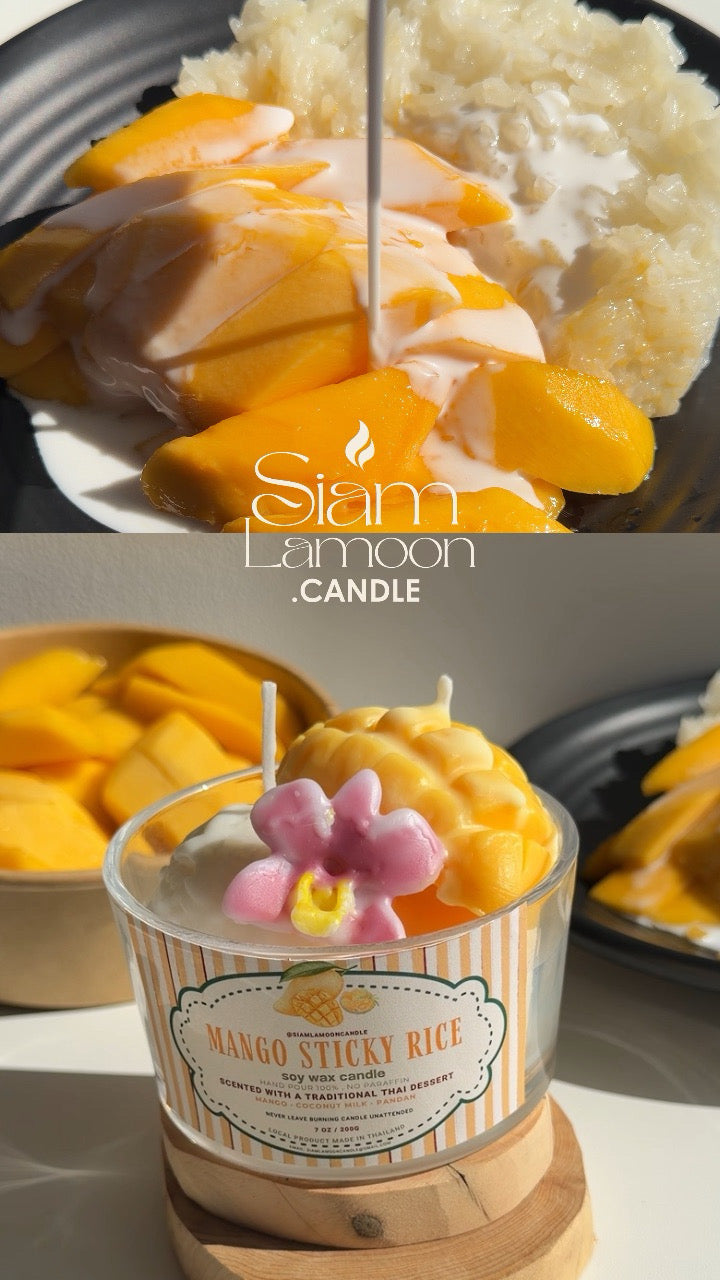 A Mango Sticky Rice candle in bright sunlight beside cut mango, sticky rice and plumeria flowers