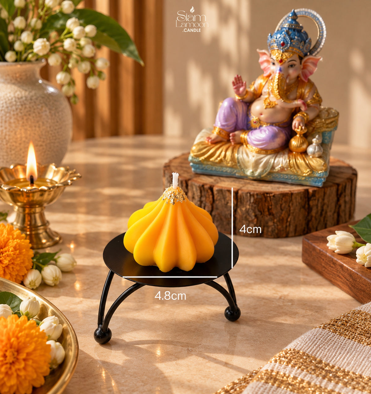Close-up of the genuine gold leaf laid around the wick of a modak candle
